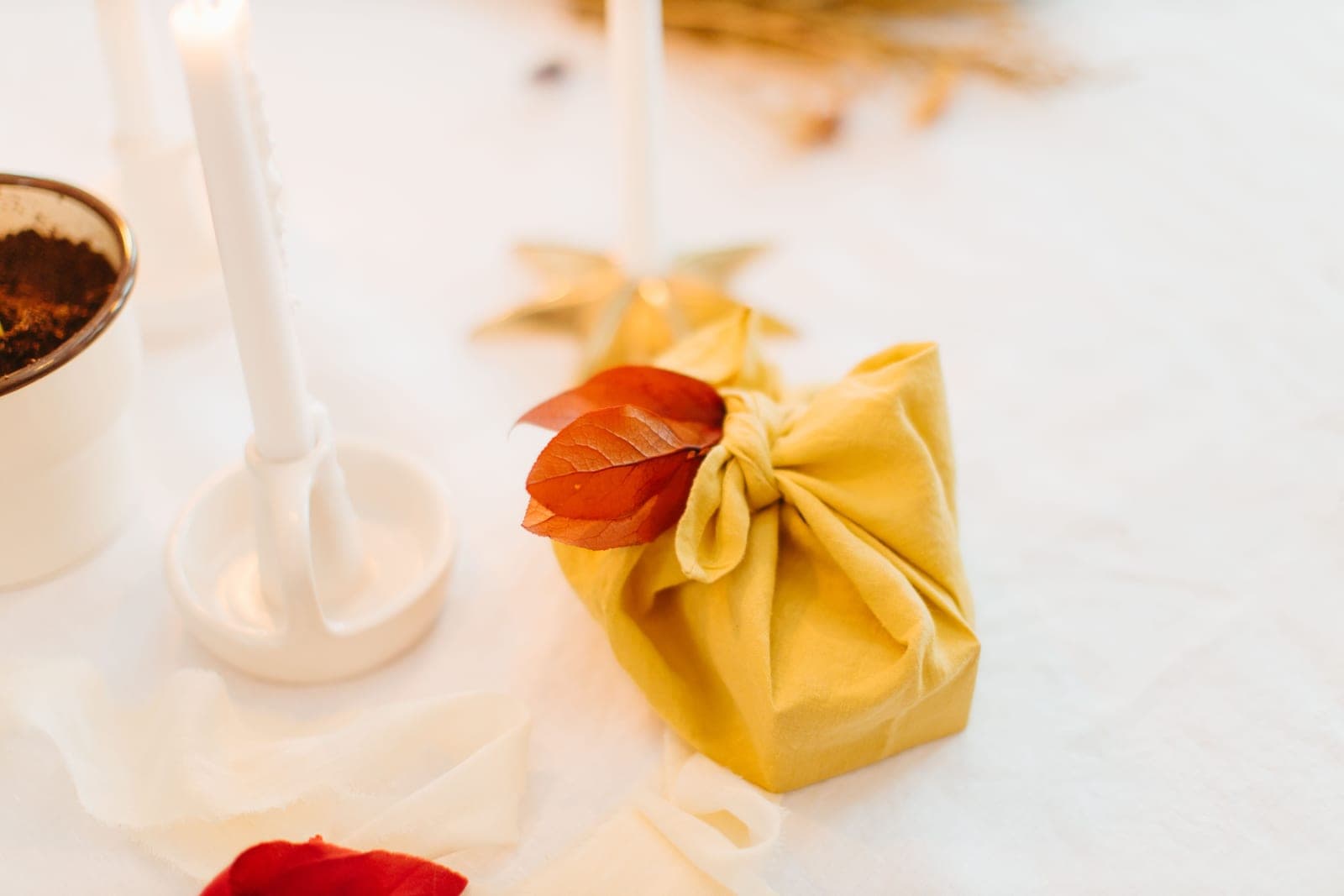 A wrapped handmade candle prepared as a gift