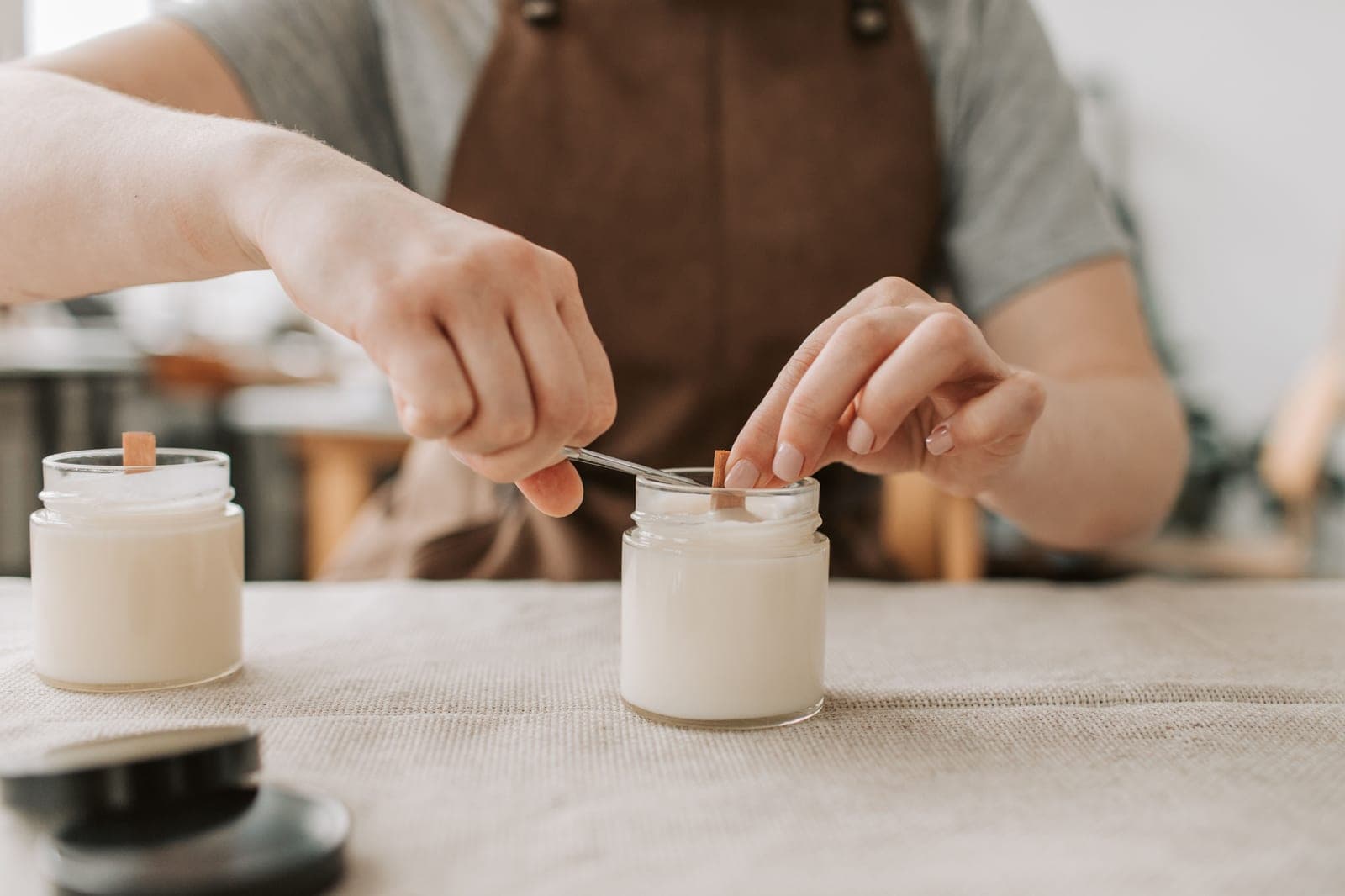 Candle wicks laid out on a workshop bench